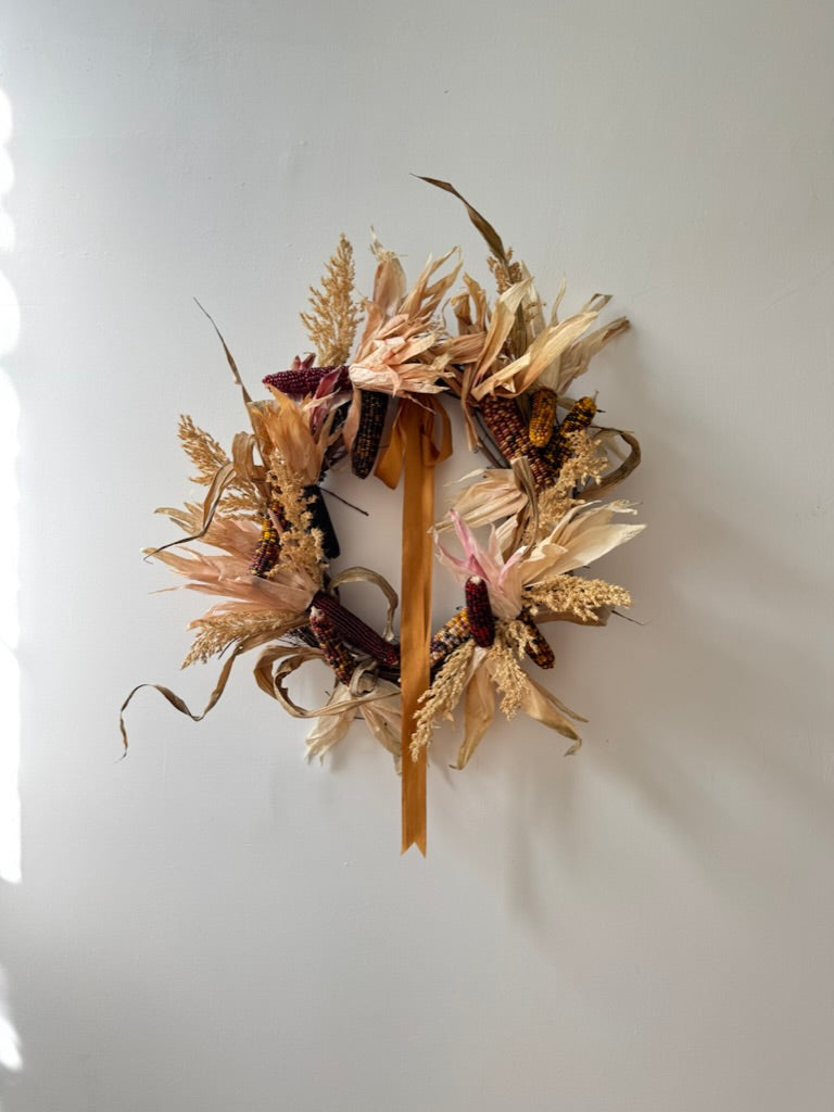 Dried floral wreath on a white wall