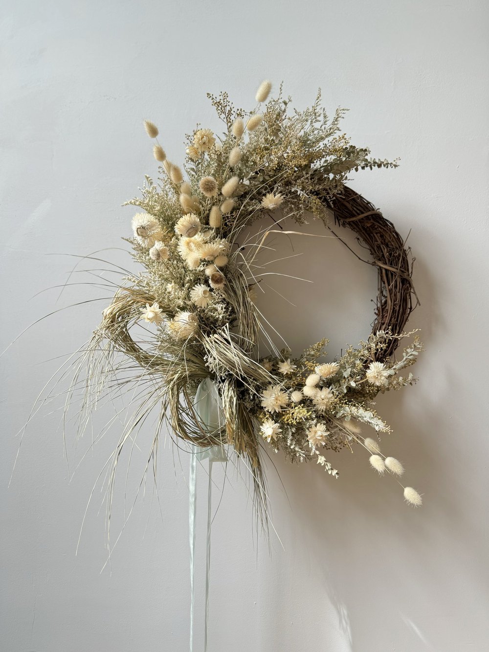 Decorative wreath with dried flowers on a white background