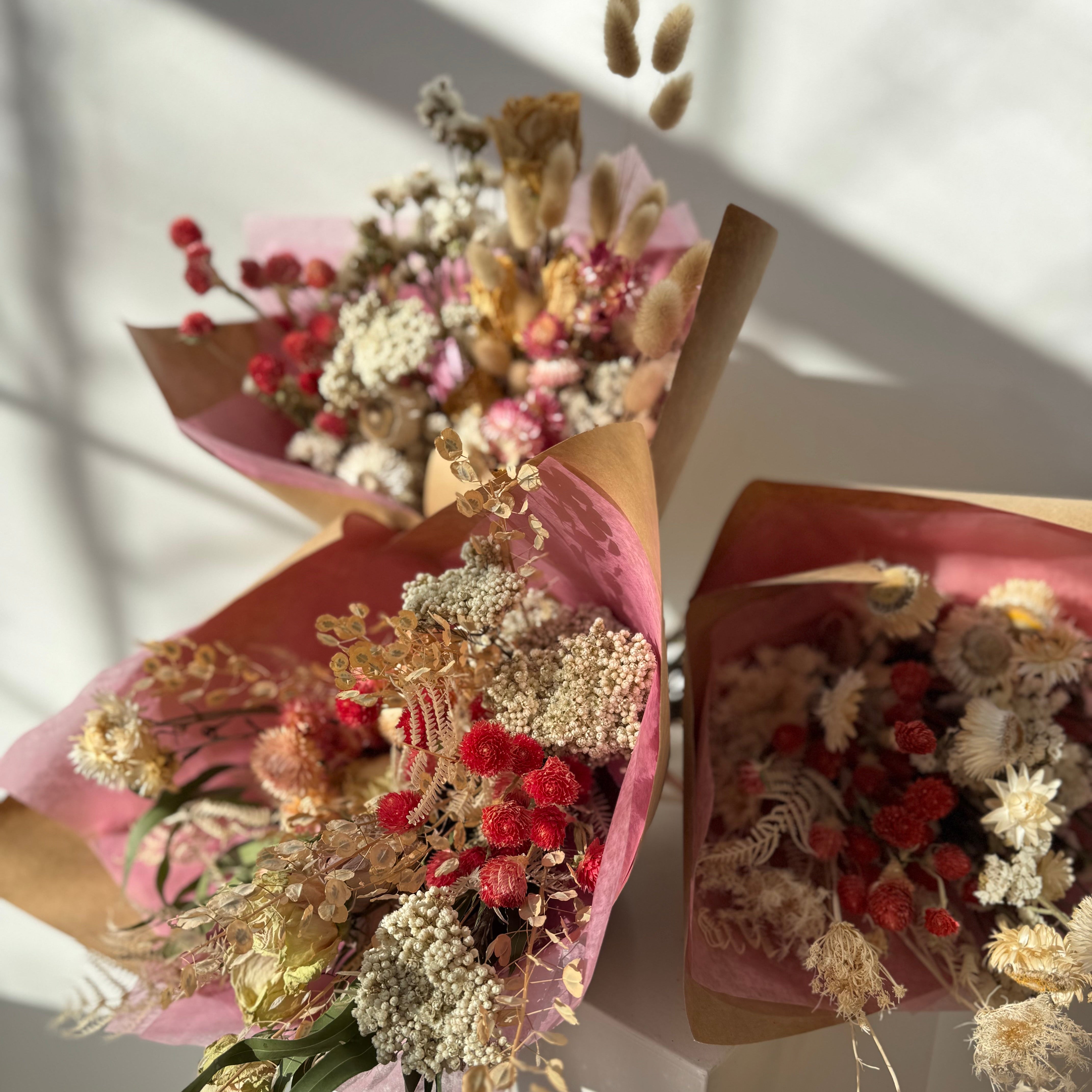Valentine's Day delivery of dried flowers in pink paper wrapping for Maine