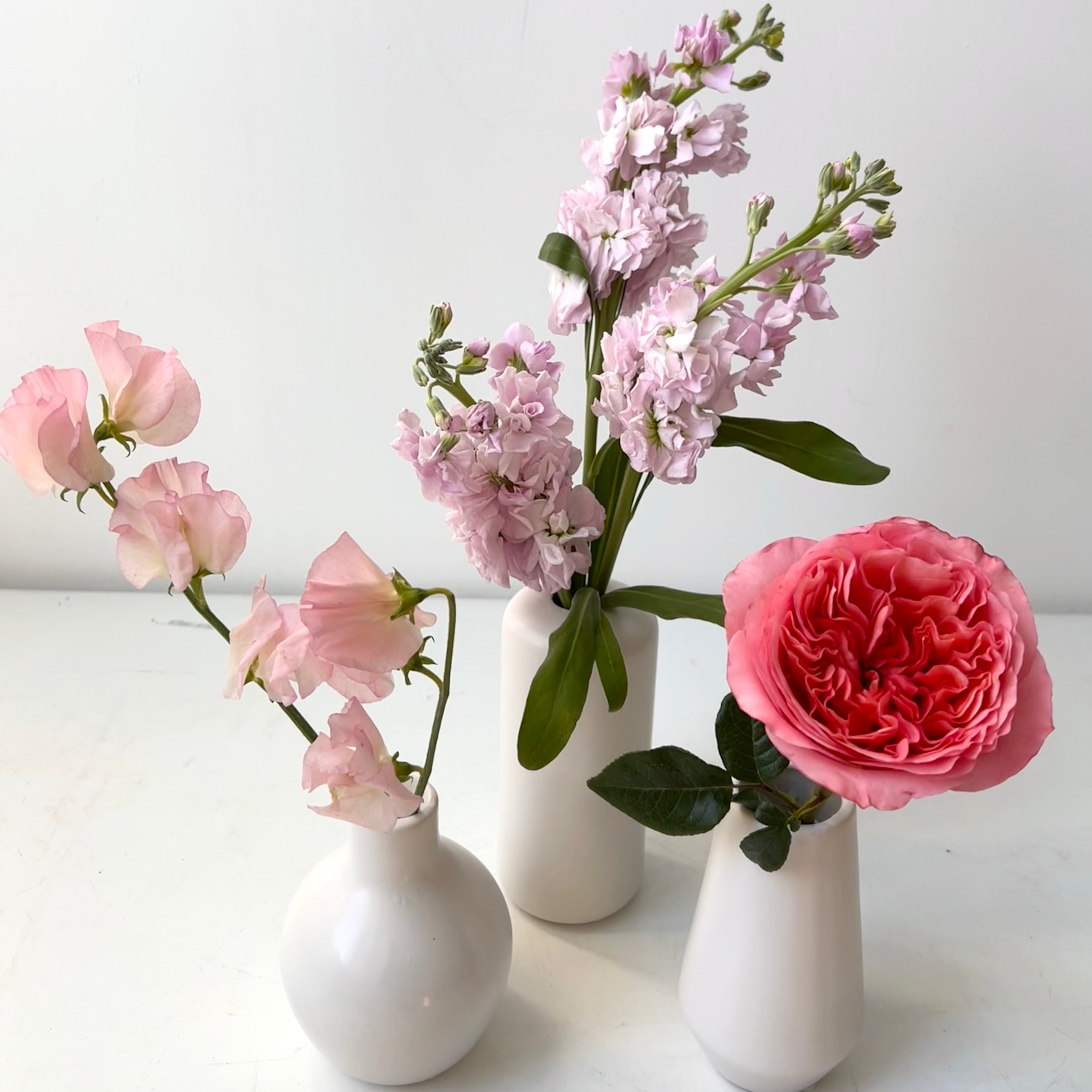 Three bud vases with pink valentine's day flowers for delivery to portland maine