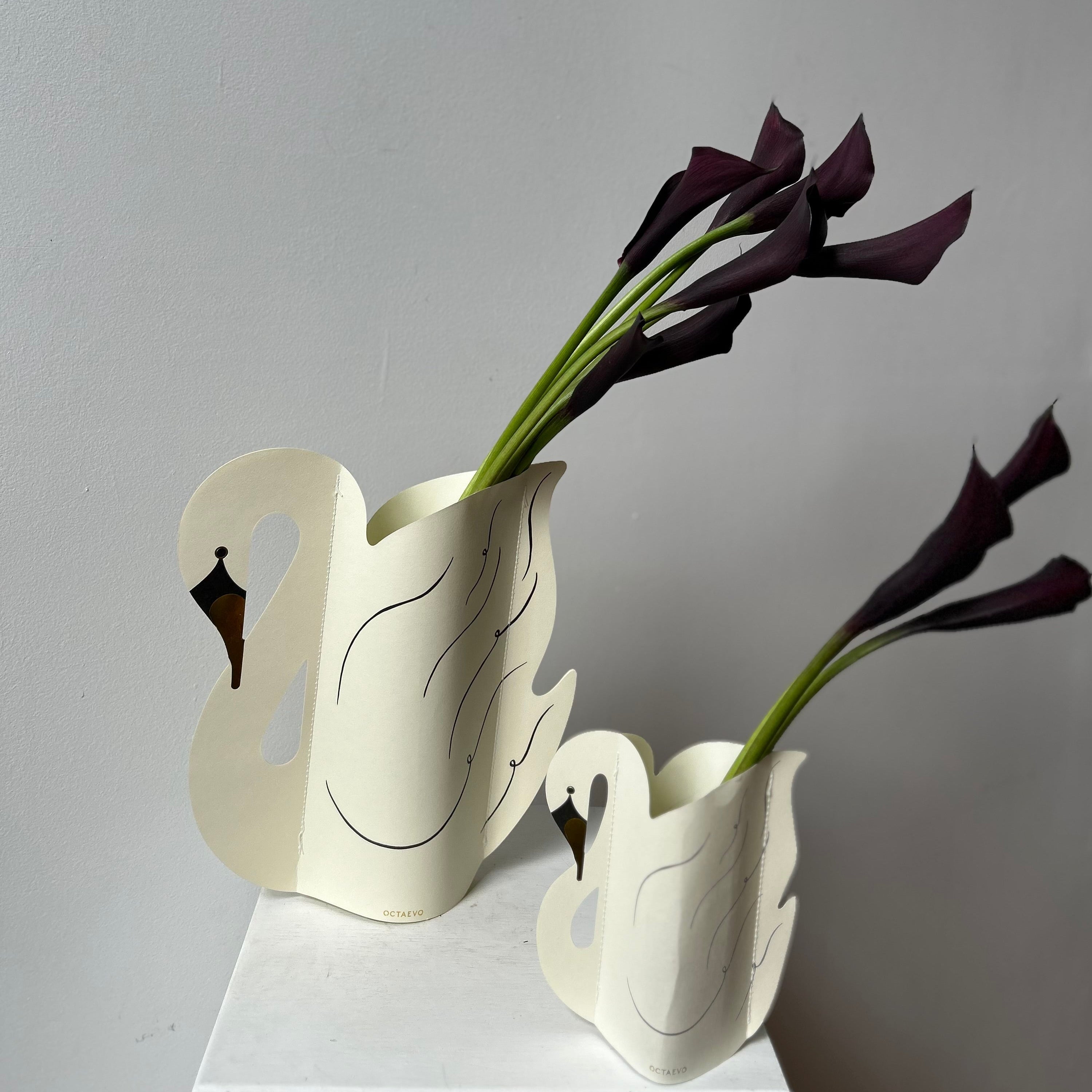 black flowers in a paper swan vase for flower delivery in portland maine