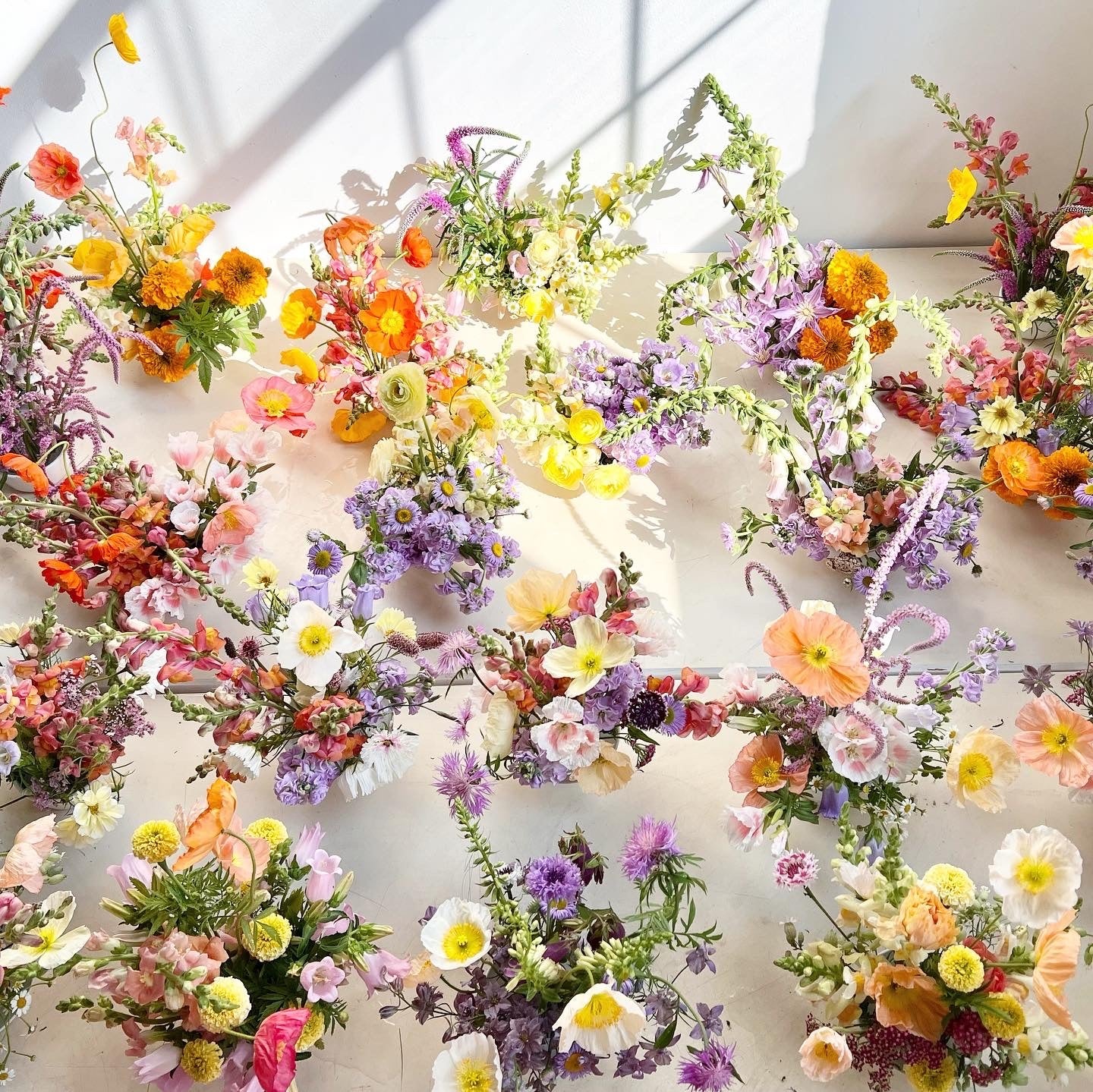 Colorful floral arrangements on a white wall