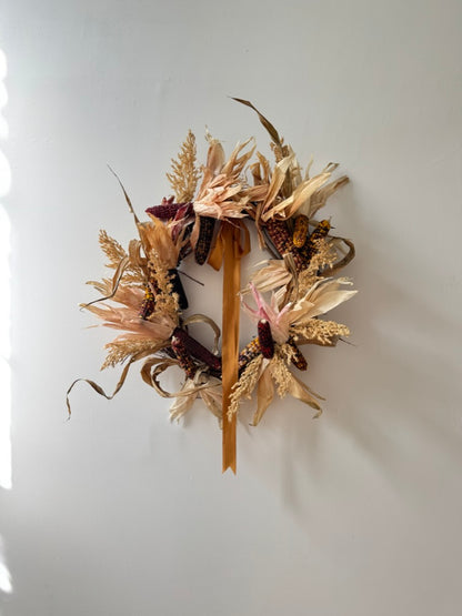 Dried floral wreath on a white wall