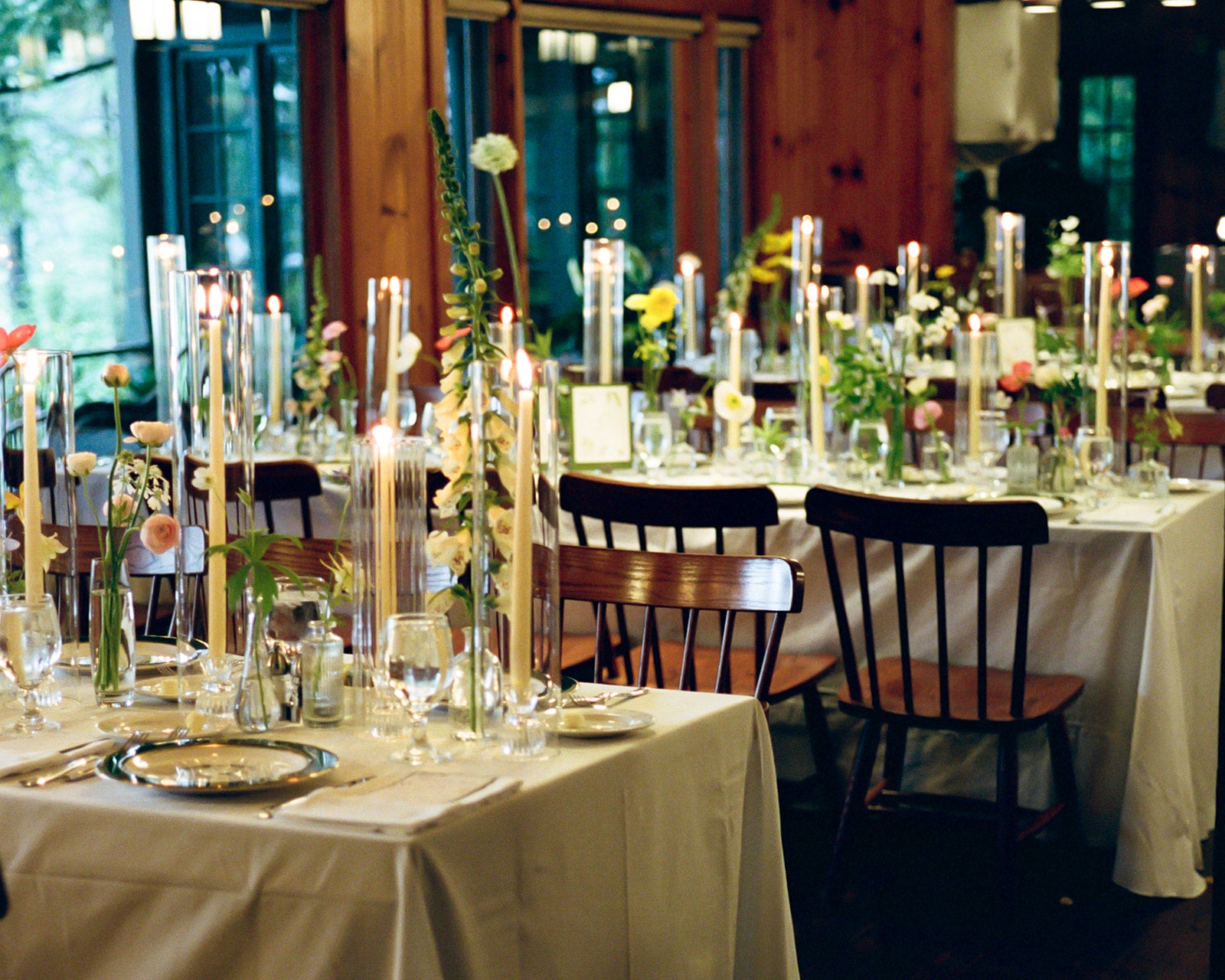 Decorated tables with candles and flowers in a formal setting