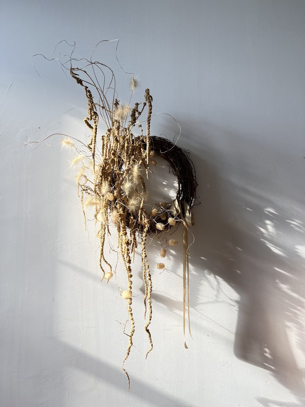 Decorative wreath with natural elements on a white wall