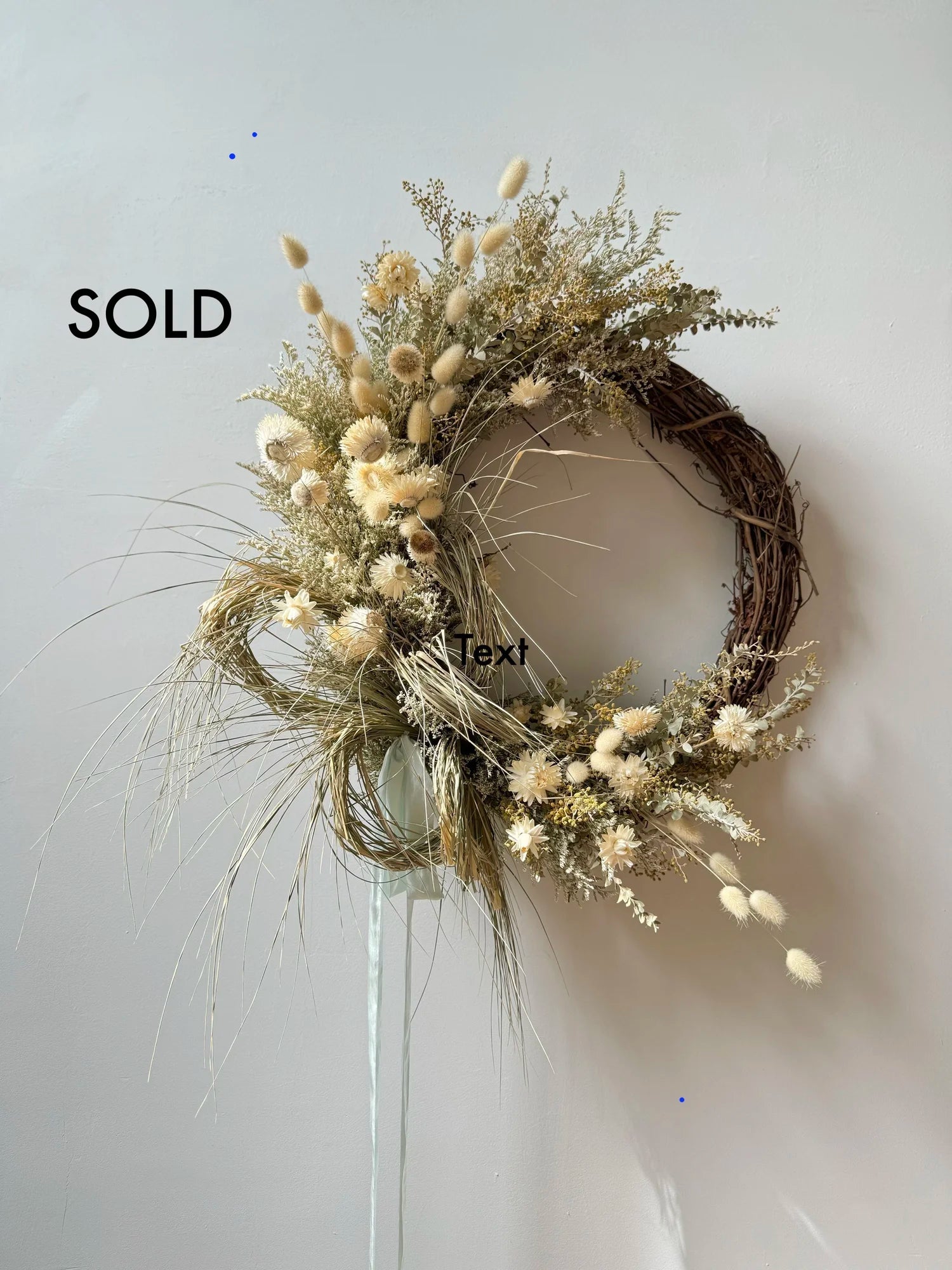 Decorative wreath with dried flowers on a white background, labeled 'SOLD'.
