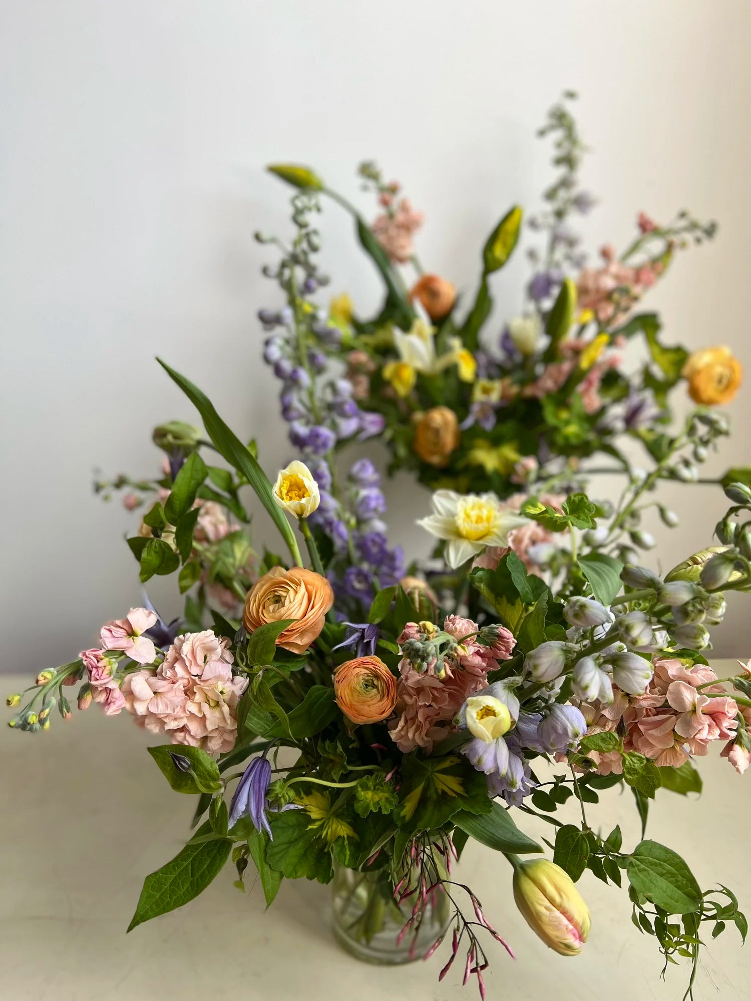 Bouquet of flowers in a clear vase on a light background