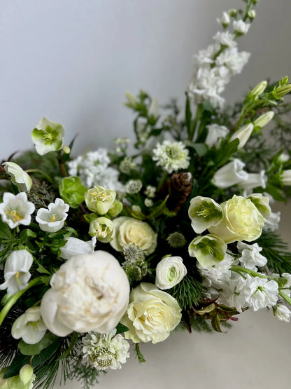 Bouquet of white and green flowers on a light background