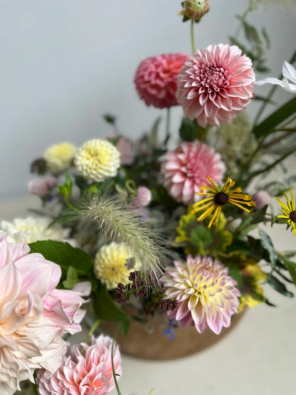 Bouquet of flowers with pink, yellow, and green colors on a light background