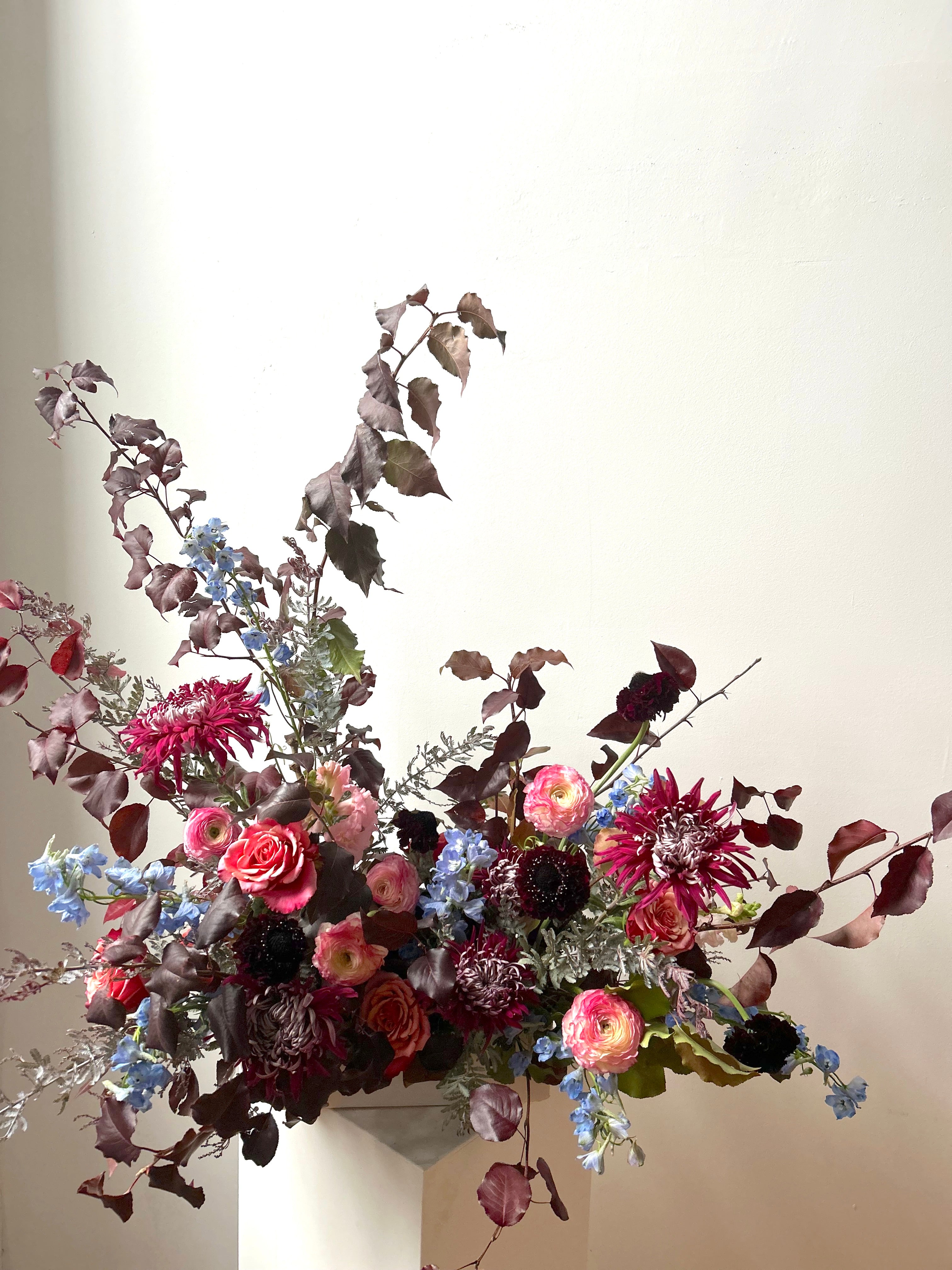 Moody Maine fall wedding statement arrangement with a neutral background