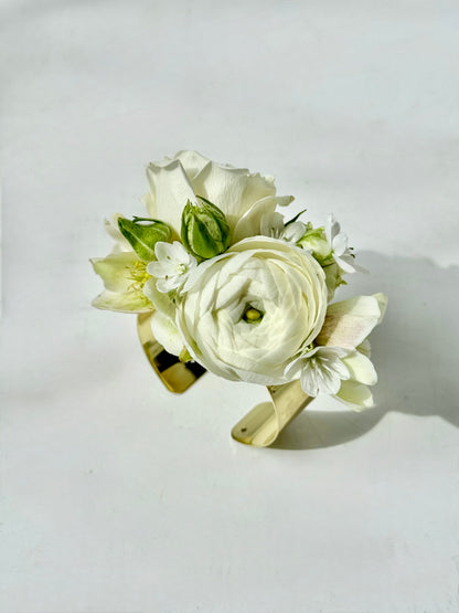 Wristlet for maine weddings featuring white ranunculus and little white allium flowers