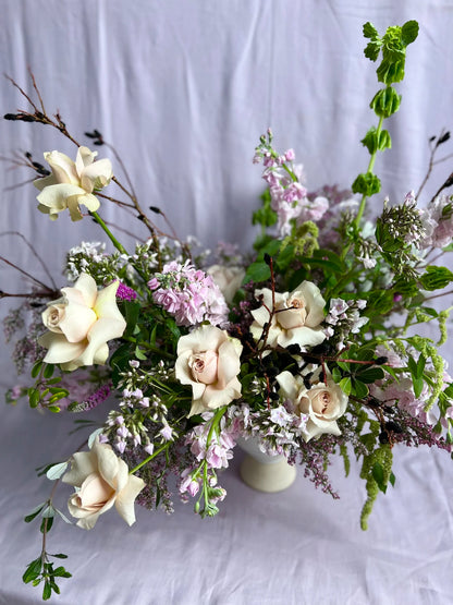 Floral arrangement with white and purple flowers on a white background