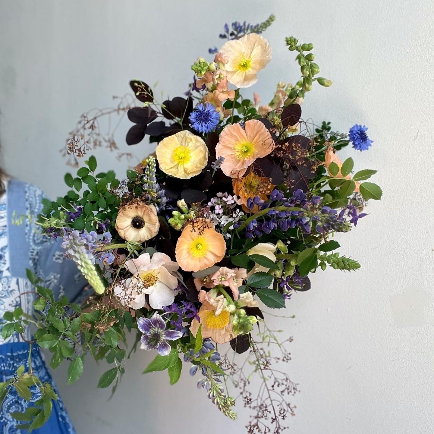 Colorful flower arrangement on a light blue background