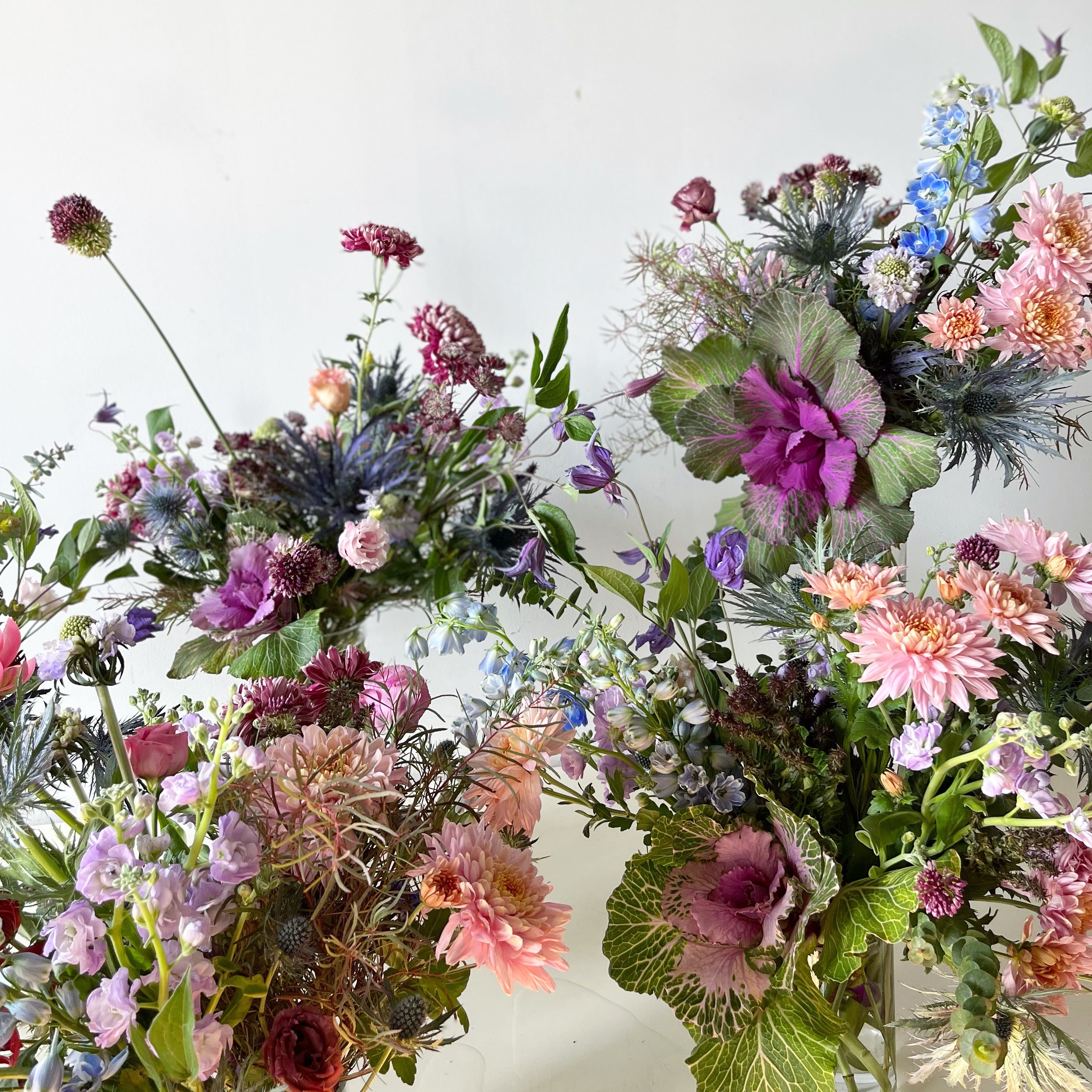 Three vibrant flower bouquets on a white background