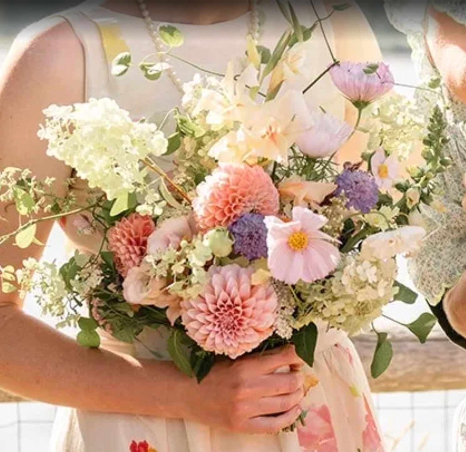 Bouquet of flowers held by a person with a blurred background
