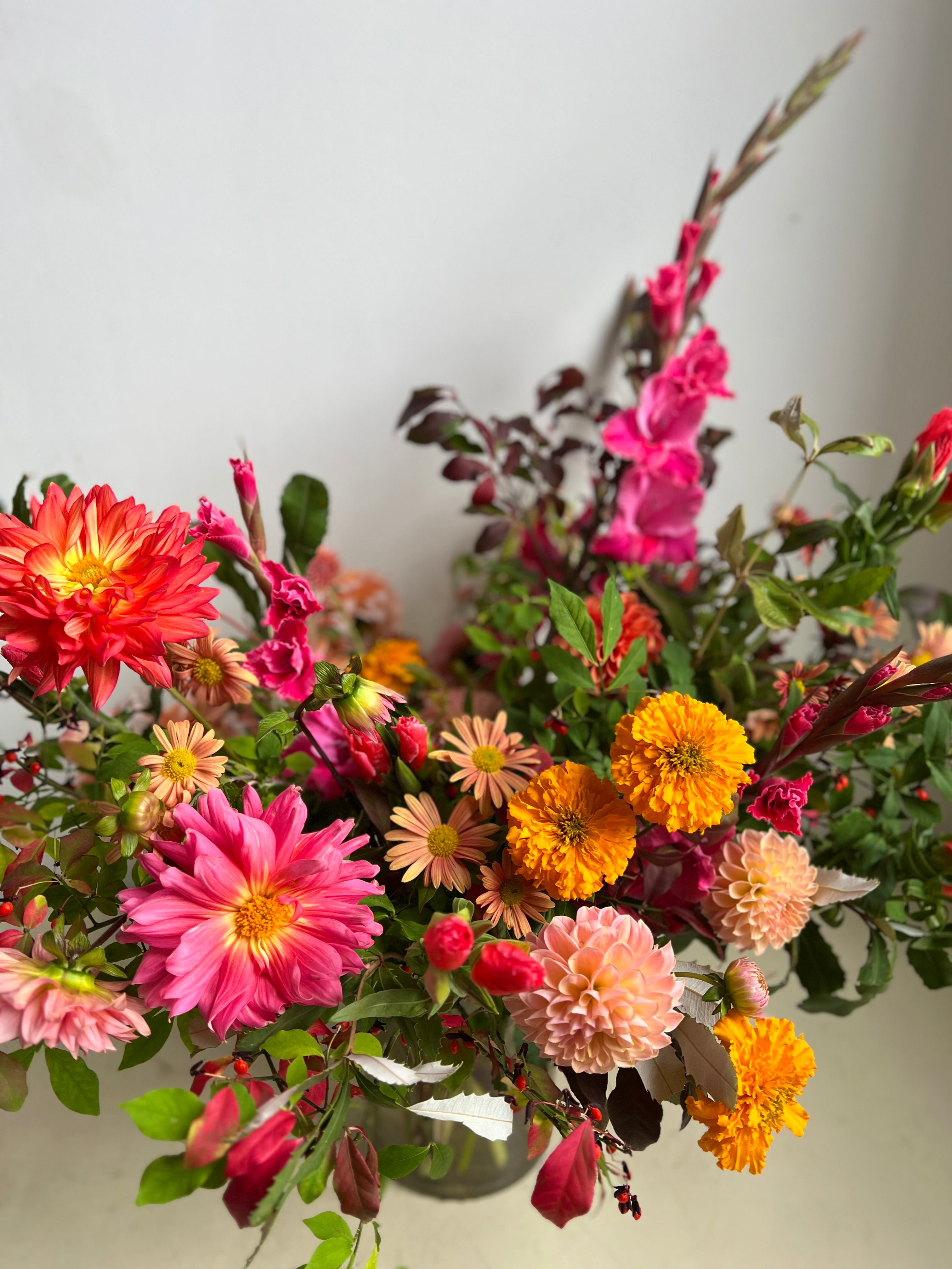 Colorful flower arrangement with pink, orange, and yellow flowers mothers day delivery from portland maine florist
