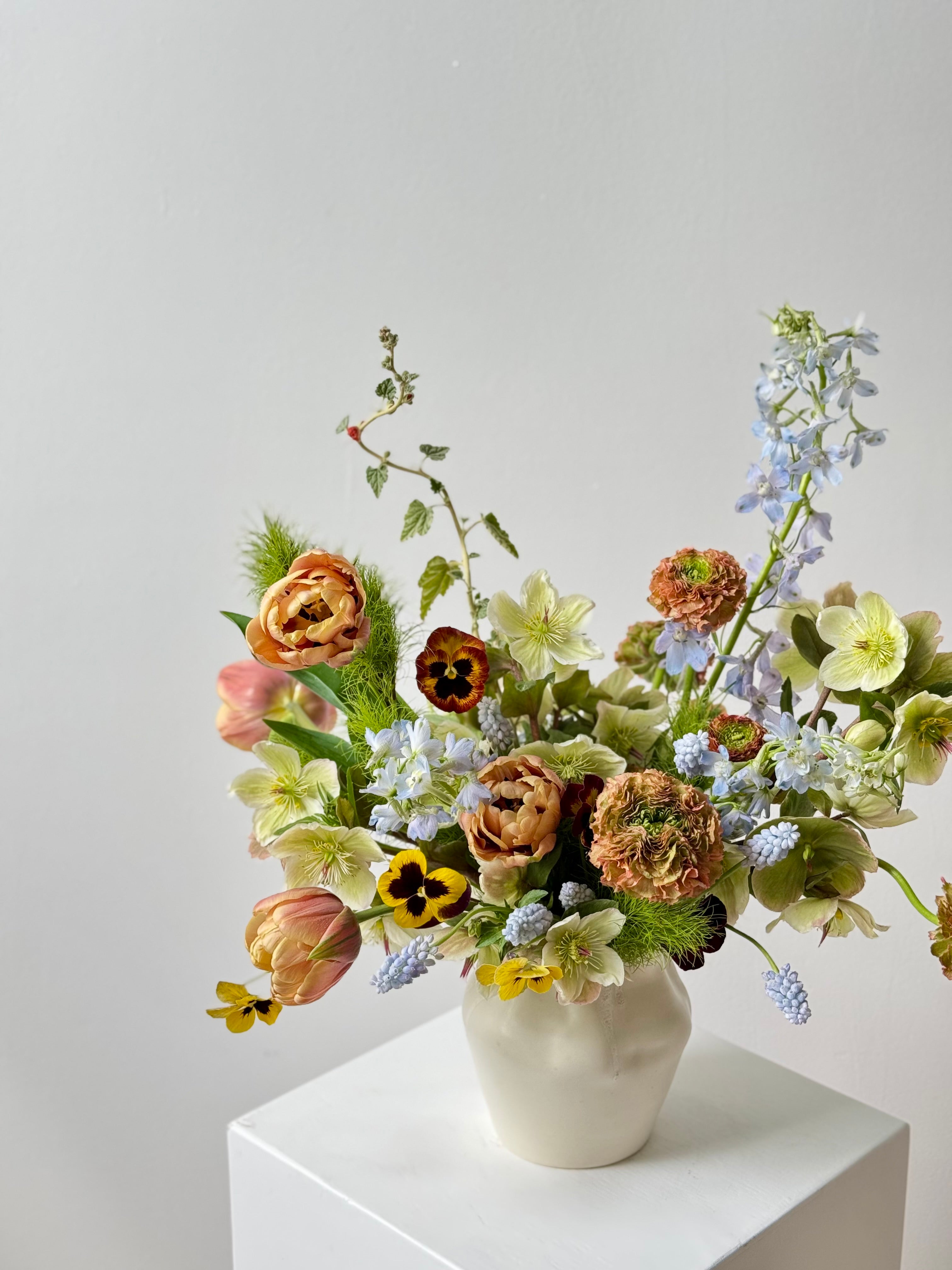 portland maine florist birthday floral arrangement in a white vase on a white surface with a light gray background