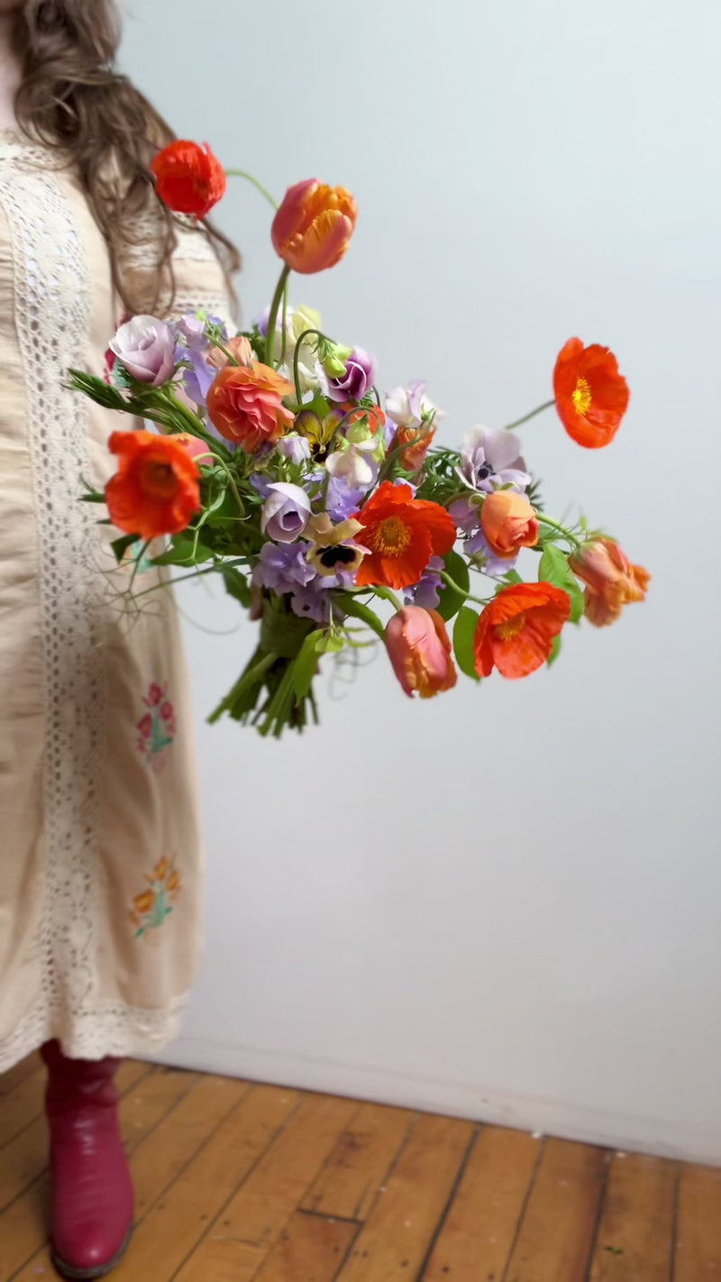 Colorful arrangement with orange and purple flowers